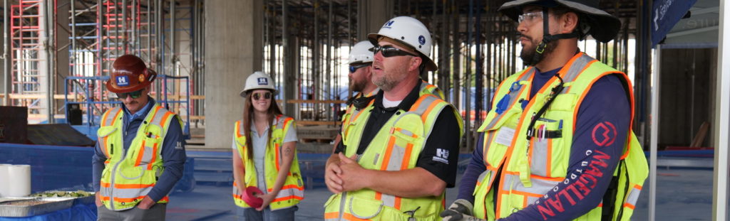 charter construction team gathering at a job site